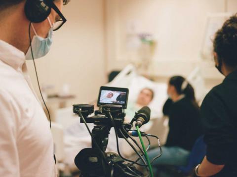 Film crew filming a COVID-19 patient