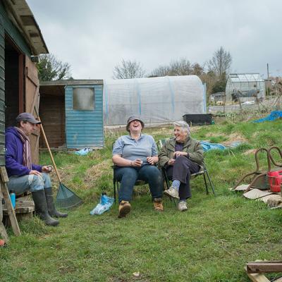 Three people sitting in an allotment