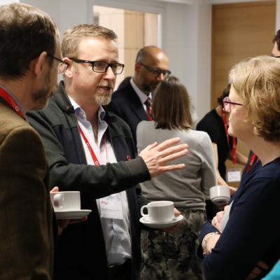 Health Foundation alumni chatting over coffee at an event